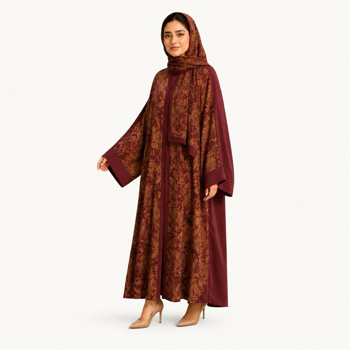 Rich burgundy abaya with an intricate paisley print and solid burgundy cuffs and trim, worn with a coordinating draped shawl.