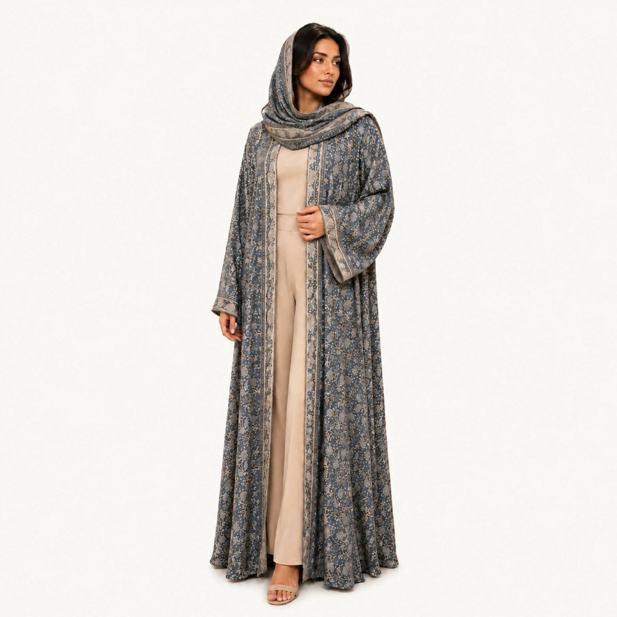 Indian silk abaya, bisht-style cut, in cream with black trim and a floral pattern styled as black tucks, square sleeves, loose and lightweight. Hand wash or steam clean.
