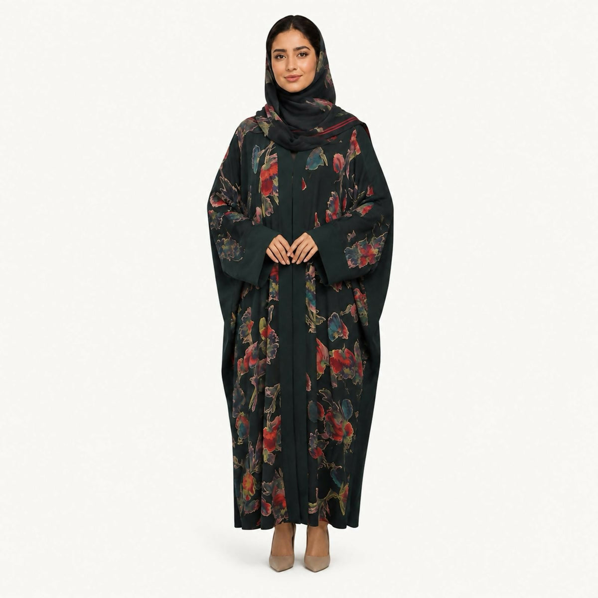 Deep green abaya featuring a bold multicolor floral print down the front panels, styled with a plain black hijab.