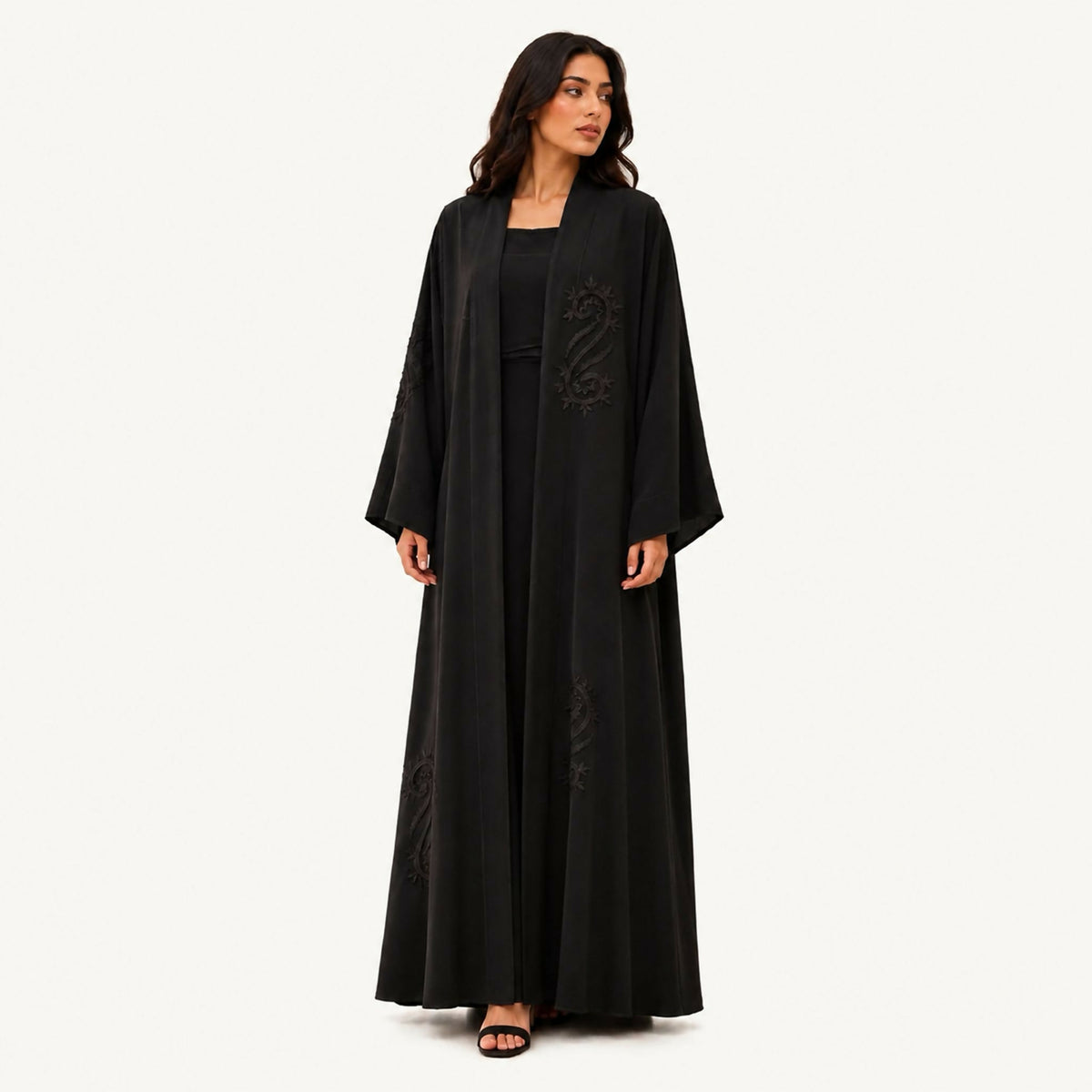 Black crepe abaya with self-fabric seam lines plus front floral embroidery covering half the abaya, and side panels on the right and left in black. Fabric works for both summer and winter; hand wash or steam clean.