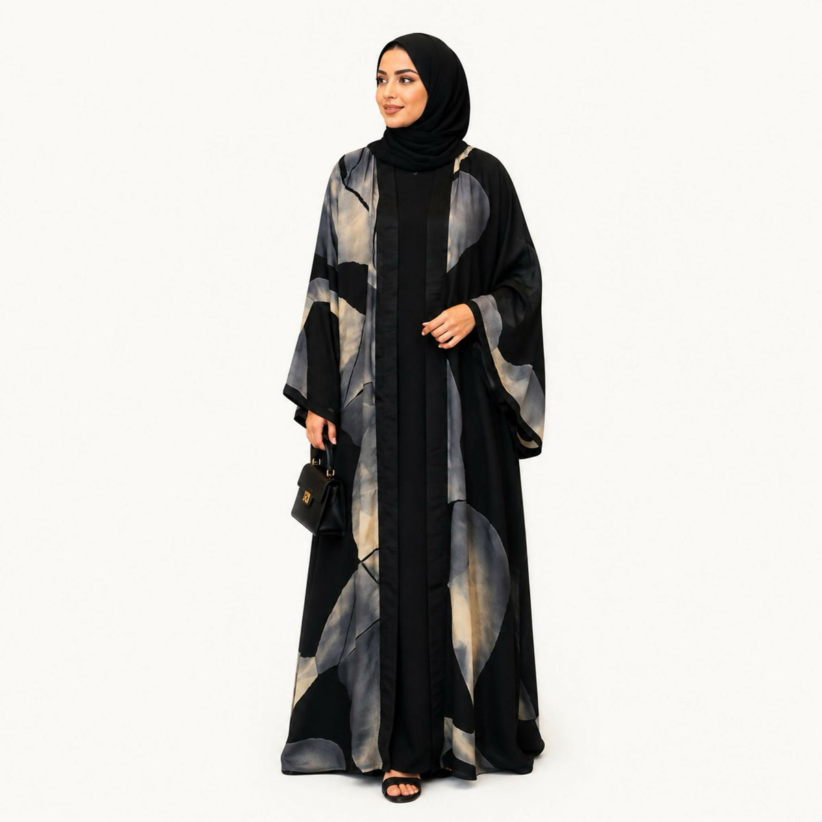 Indian silk abaya, bisht-style cut, in black with a large off-white flower, square sleeves, loose and lightweight. Hand wash or steam clean.