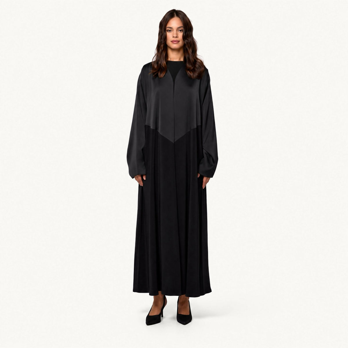 Two-tone abaya combining a matte satin yoke with a flowing crepe body, round neckline, and dolman-style sleeves.