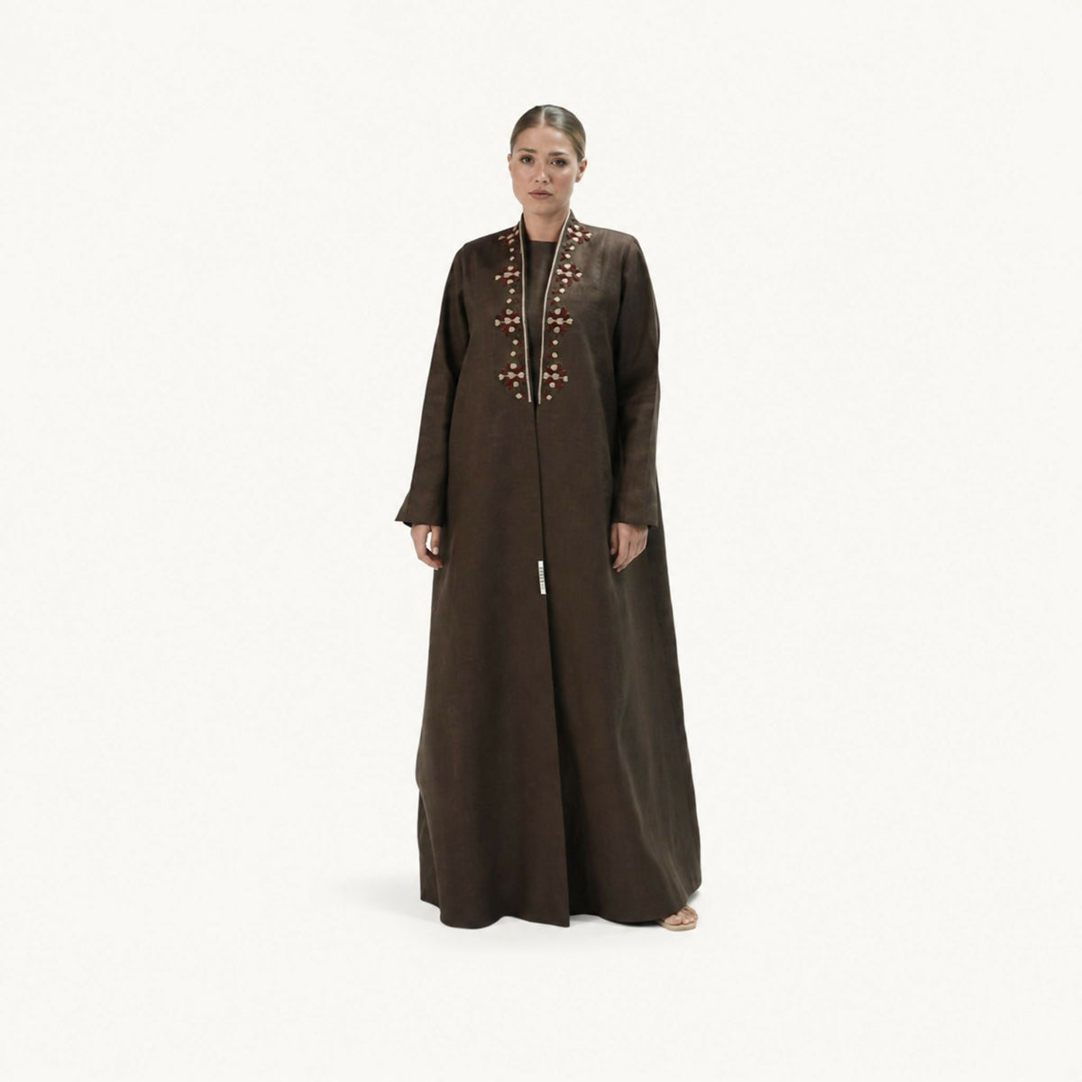 Elegant abaya featuring handcrafted woven thread detailing inspired by artistic craftsmanship. Designed with a flowing silhouette that beautifully blends artisanal craftsmanship with modern elegance, making it perfect for a variety of occasions