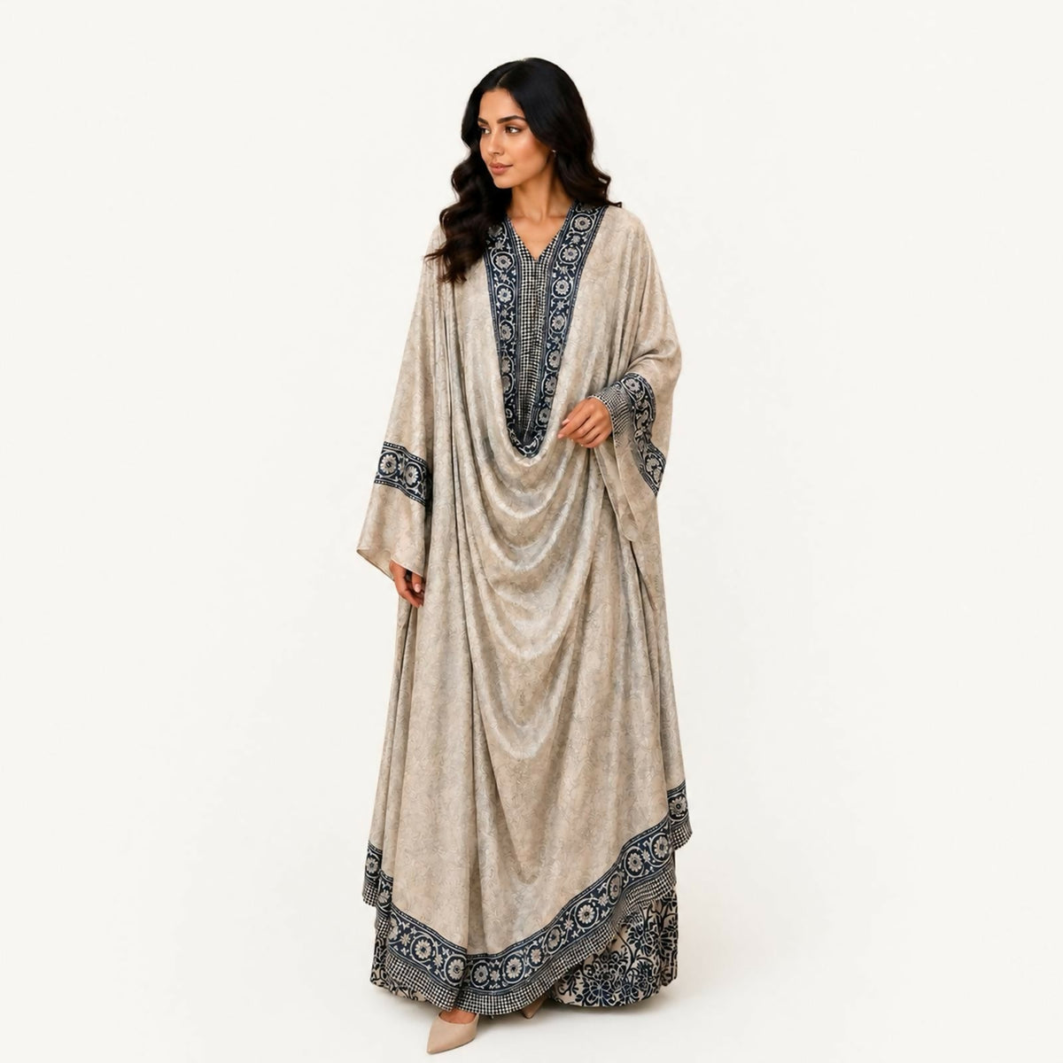 Indian silk jalabiya with a two-layer cut, the top layer cut as a loose cape resembling a butterfly, in light grey with dark grey trim. Hand wash or steam clean.