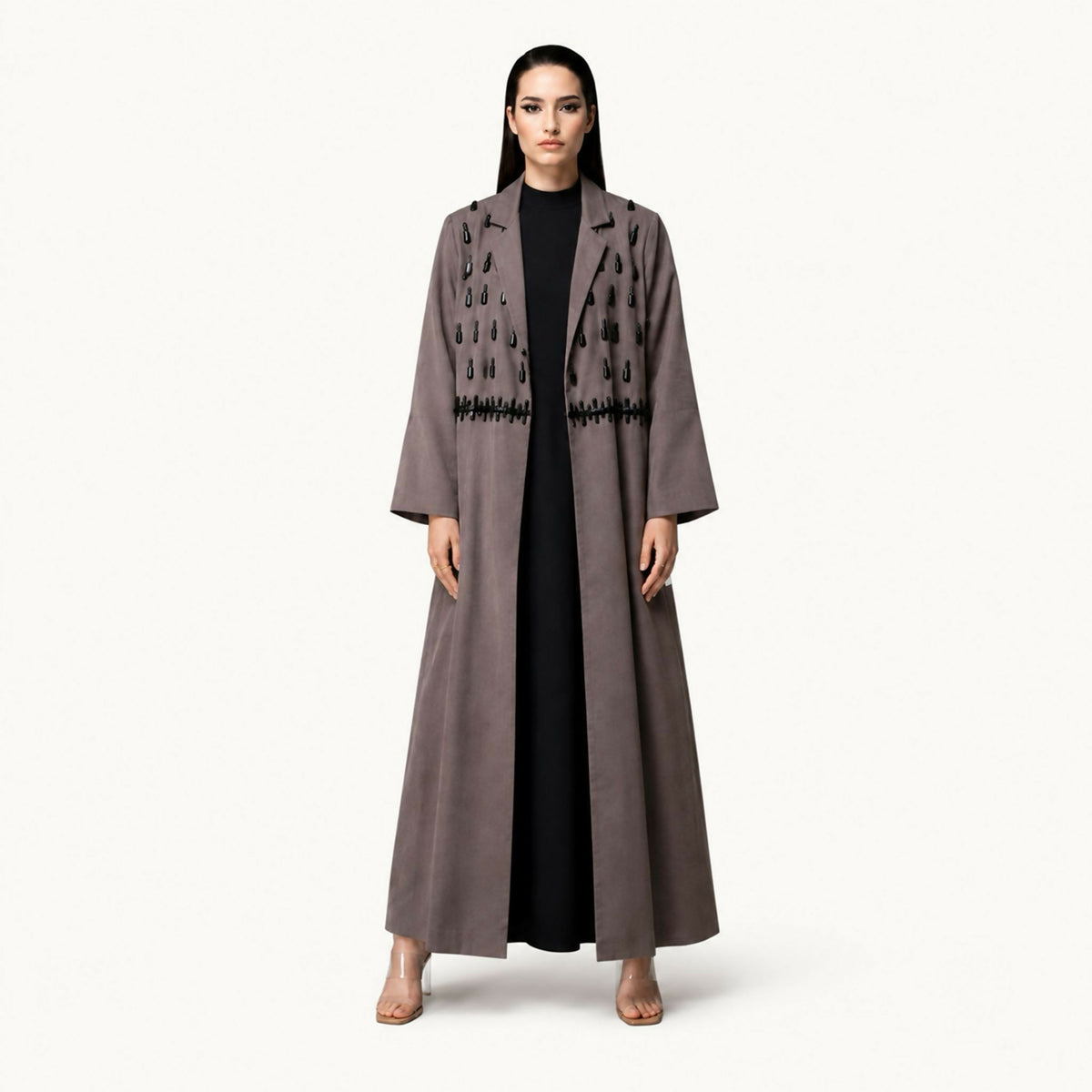 Sophisticated blazer abaya featuring intricate hand embroidery accented with bold black stones and elegant geometric detailing. Combining exceptional craftsmanship with contemporary elegance, it offers a refined look perfect for a variety of occasions