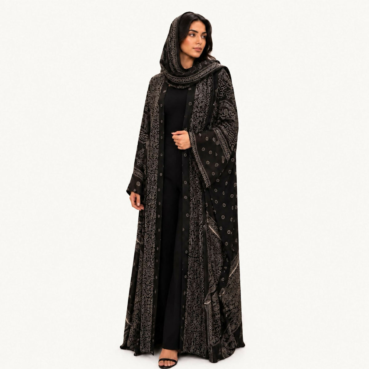 Indian silk abaya, bisht-style cut, in black with light and dark gold accents, square sleeves, loose and lightweight. Hand wash or steam clean.